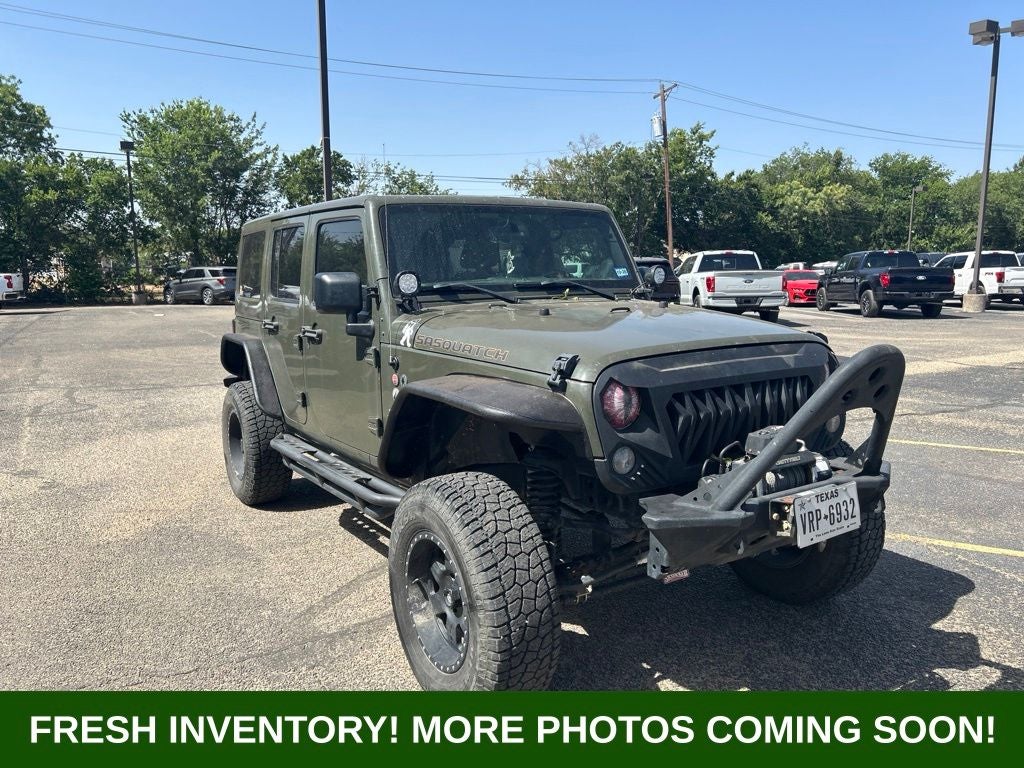 2015 Jeep Wrangler Unlimited Sahara in Tank Clearcoat — front three-quarter view